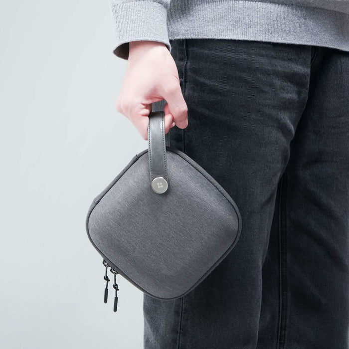 AFA09214 - Mac Mini M4 Klasden Pouch in Charcoal Gray showing the pouch held by it's strap