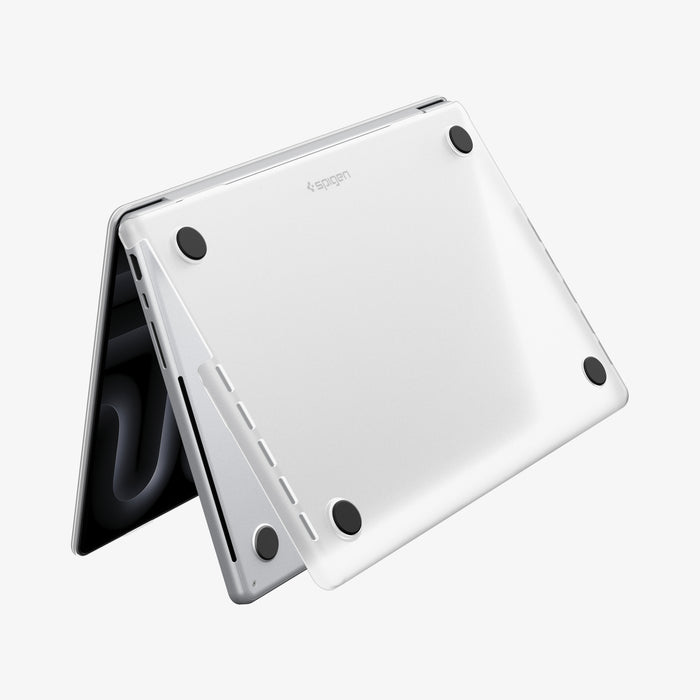 ACS11526 - MacBook Pro 16-inch Air Skin in Frost Clear showing the bottom exterior with four rubber feet and the Spigen logo visible on a white background