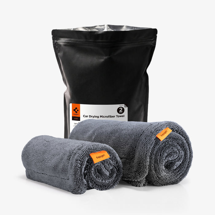 ACP11389 - Spigen CC100 Car Drying Microfiber Towel 2-pack packaging bag next to two rolled gray towels with orange tags