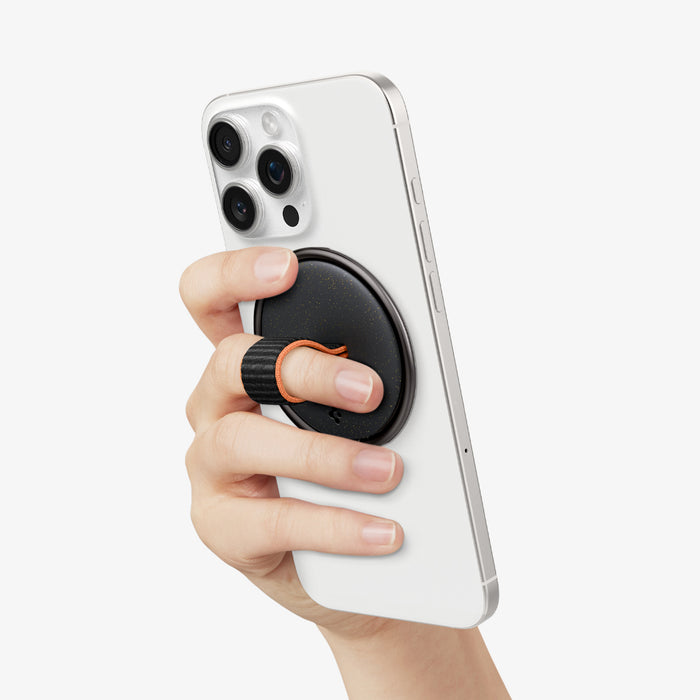 AMP08552 - O-Mag Magnetic Phone Holder (MagFit) OM104 in Black showing a person's hand holding the device confidently and conveniently with o-mag ring installed