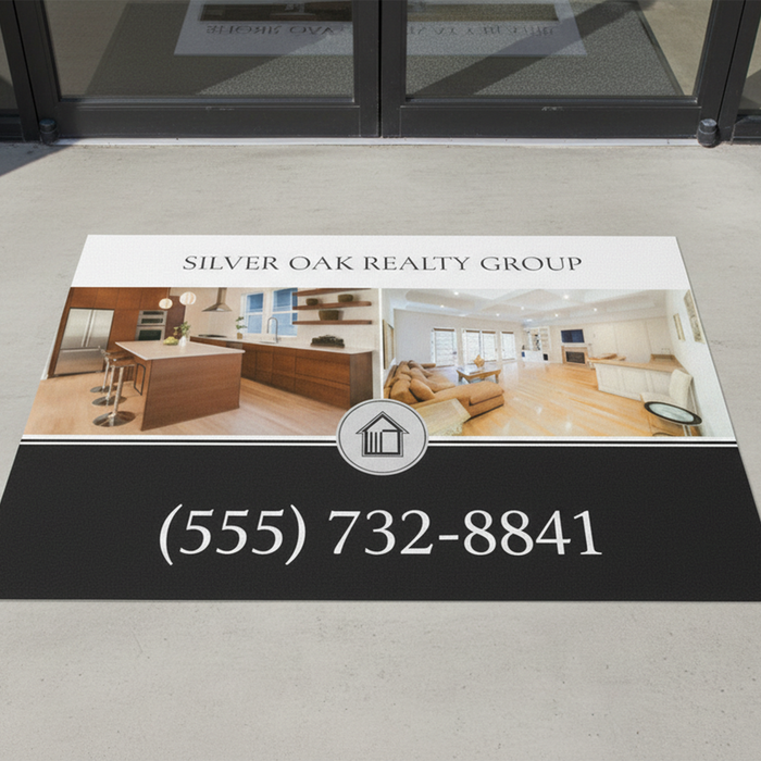 Real estate promotional mat with 'Silver Oak Realty Group' contact information on a floor.