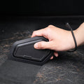 ACP11829 - Hand holding the Spigen car detailing scraper over a surface covered in pet hair