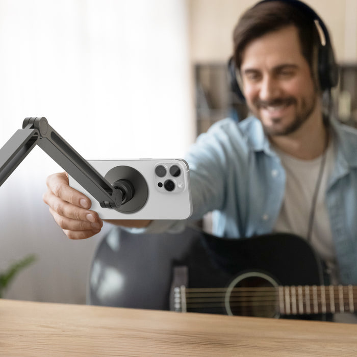 AMP09694 - Phone OneTap Clamp (MagFit) in Space Gray showing a person adjusting the device from the phone holder