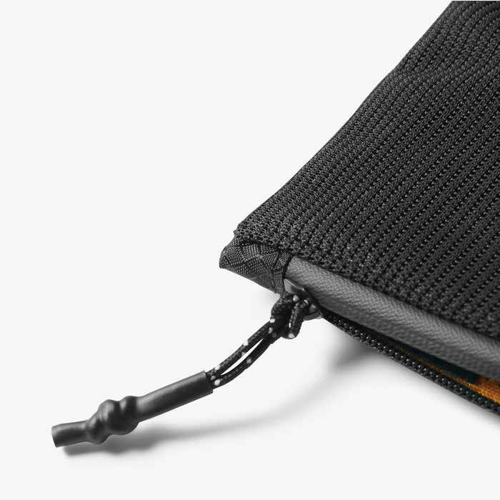 AFA11229 - Soft Card Holder | LF300 in Black showing close-up of the bottom corner zipper detail with braided cord pull tab and yellow interior lining visible.