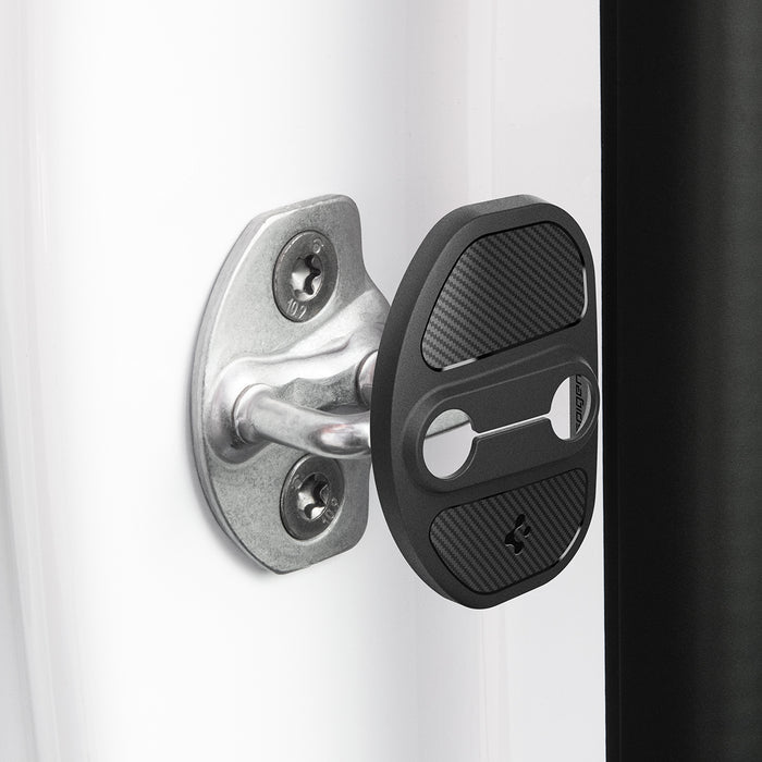ACP07123 - Tesla Model Y & 3 Door Lock Cover TO320 in Black showing the door lock cover hovering in front of the door striker hook