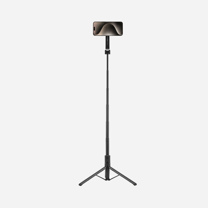 AMP07659 - Tripod Selfie Stick (Mag Fit) | S580W in Black showing the S580W selfie stick tripod fully extended as a floor-standing tripod with an iPhone mounted horizontally in landscape orientation against a light gray background.