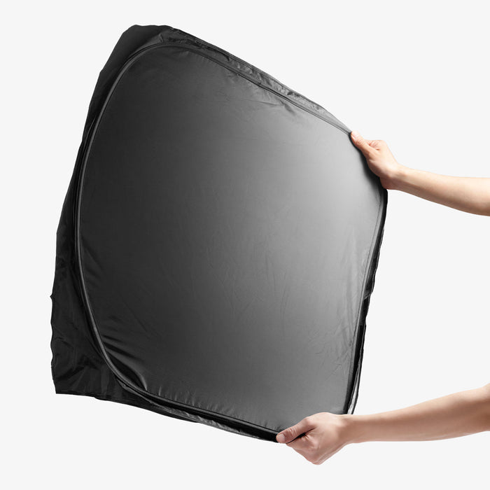 ACP11459 - Universal CryoShade UO260 S showing hands holding fully expanded black sunshade with reflective silver interior facing outward