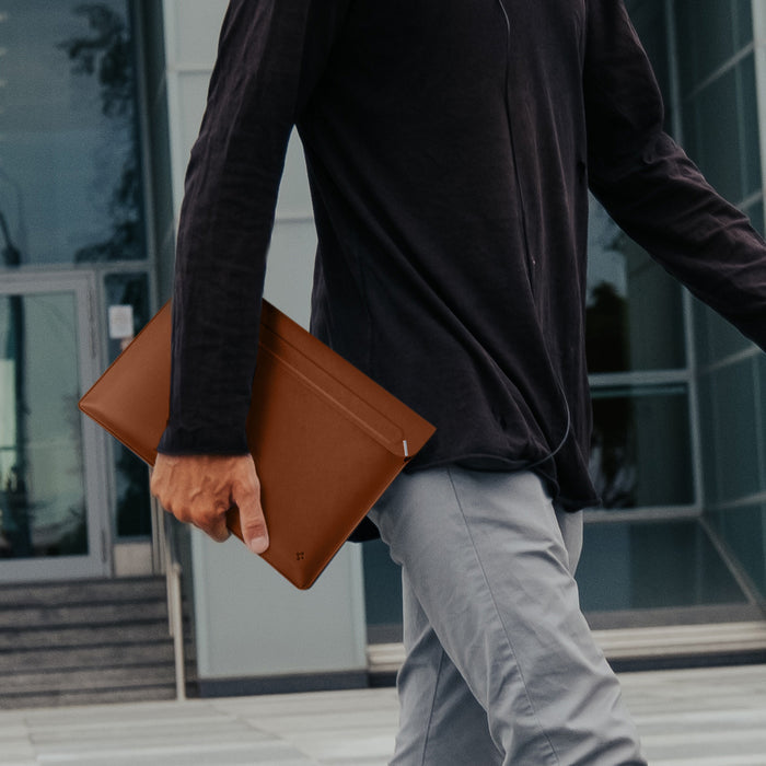 AFA06422 - Spigen Valentinus MacBook Sleeve being carried by hand outdoors
